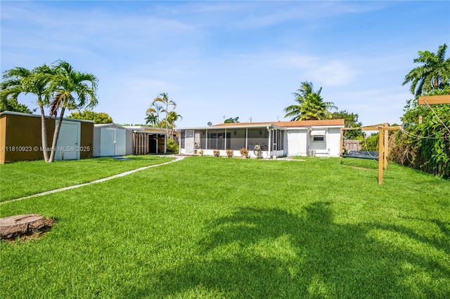 4697 SW 35th Ave, Dania Beach, FL 33312 - rear view of property featuring a sunroom and a yard