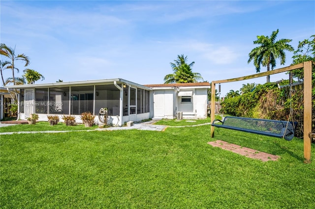 4697 SW 35th Ave, Dania Beach, FL 33312 - back of property featuring a sunroom and a lawn