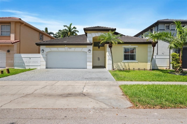 13236 SW 51st St, Miramar, FL 33027 - mediterranean / spanish-style house with a tiled roof, decorative driveway, stucco siding, and a garage