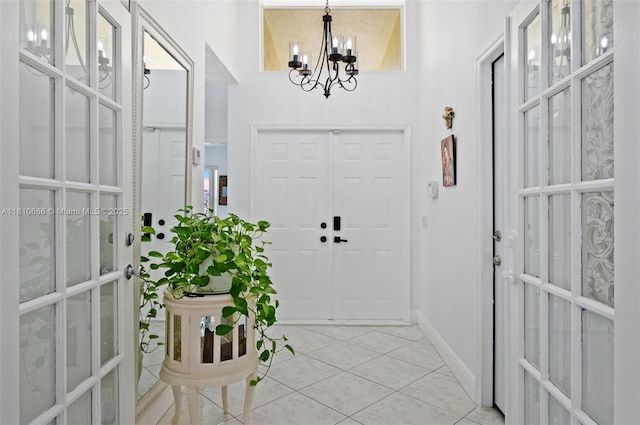 13236 SW 51st St, Miramar, FL 33027 - entryway with french doors, a chandelier, light tile patterned floors, and baseboards