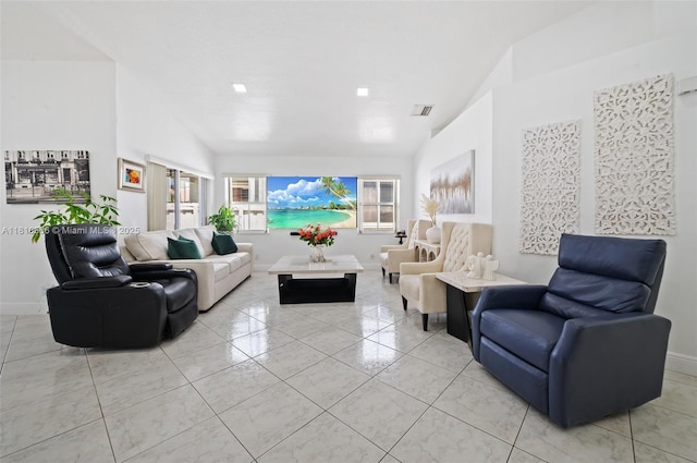 13236 SW 51st St, Miramar, FL 33027 - living area with vaulted ceiling, light tile patterned flooring, and baseboards