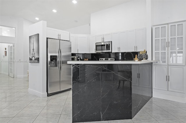13236 SW 51st St, Miramar, FL 33027 - kitchen featuring appliances with stainless steel finishes, backsplash, white cabinets, high vaulted ceiling, and recessed lighting