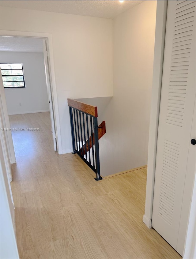550 SW 115th Ave Unit 807D, Sweetwater, FL 33174 - hall featuring an upstairs landing, wood finished floors, and baseboards