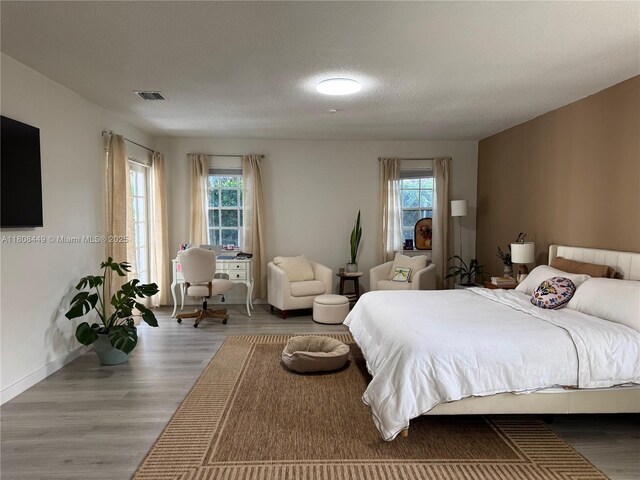 14601 SW 99th Ave, Miami, FL 33176 - bedroom featuring wood finished floors, baseboards, and a textured ceiling