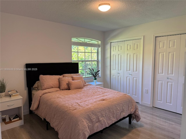 14601 SW 99th Ave, Miami, FL 33176 - bedroom featuring wood finished floors, two closets, and a textured ceiling