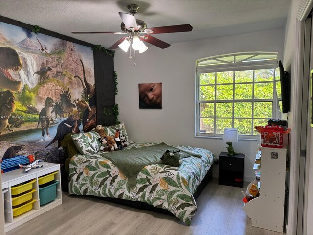 14601 SW 99th Ave, Miami, FL 33176 - bedroom with light wood-type flooring, a ceiling fan, and a textured ceiling