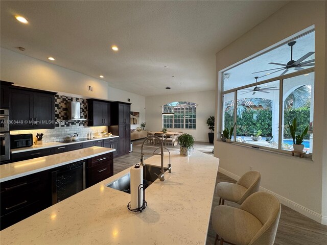 14601 SW 99th Ave, Miami, FL 33176 - kitchen with dark cabinetry, baseboards, black appliances, recessed lighting, and beverage cooler