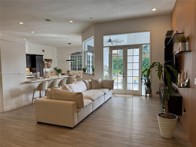 14601 SW 99th Ave, Miami, FL 33176 - living room with light wood-type flooring, recessed lighting, a textured ceiling, and ceiling fan