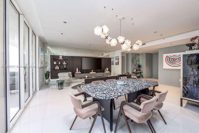 901 Brickell Key Blvd Unit 906, Miami, FL 33131 - tiled dining area with a chandelier