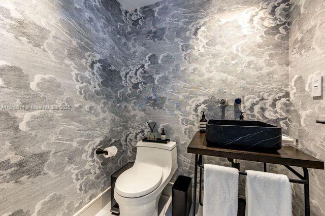 901 Brickell Key Blvd Unit 906, Miami, FL 33131 - bathroom with a sink, toilet, and baseboards