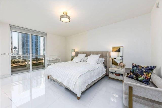 901 Brickell Key Blvd Unit 906, Miami, FL 33131 - bedroom with light tile patterned flooring and access to exterior
