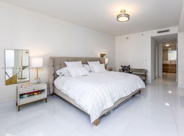 901 Brickell Key Blvd Unit 906, Miami, FL 33131 - bedroom featuring light tile patterned floors and baseboards