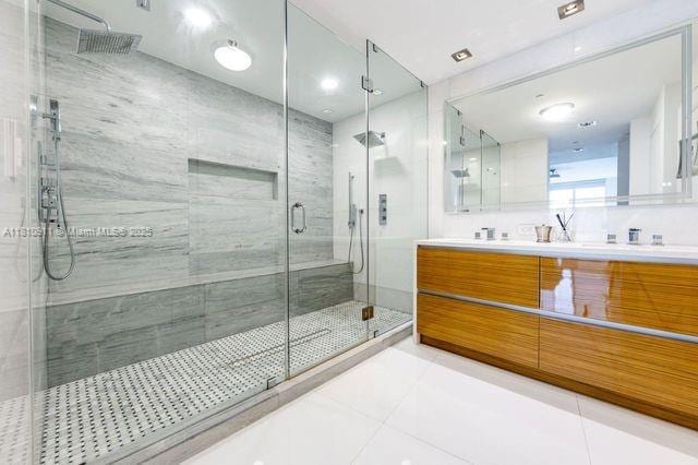 901 Brickell Key Blvd Unit 906, Miami, FL 33131 - bathroom with vanity, a shower stall, and tile patterned floors