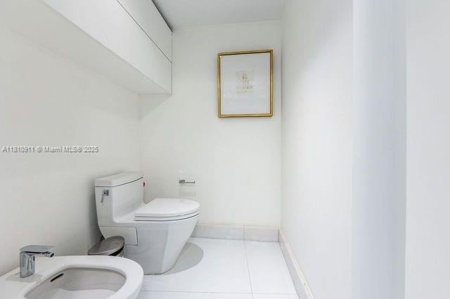 901 Brickell Key Blvd Unit 906, Miami, FL 33131 - bathroom featuring a bidet, toilet, and tile patterned flooring