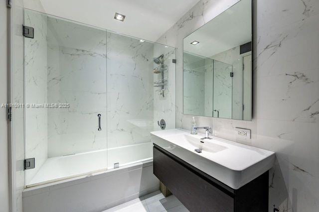 901 Brickell Key Blvd Unit 906, Miami, FL 33131 - full bathroom featuring tile walls, vanity, and shower / bath combination with glass door