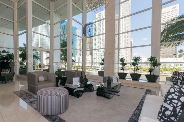 901 Brickell Key Blvd Unit 906, Miami, FL 33131 - community lobby featuring a high ceiling, floor to ceiling windows, and a view of city