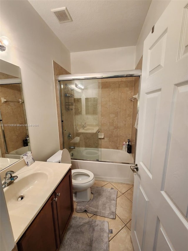 11249 NW 87th Ter, Doral, FL 33178 - bathroom with vanity, toilet, shower / bath combination with glass door, and tile patterned floors