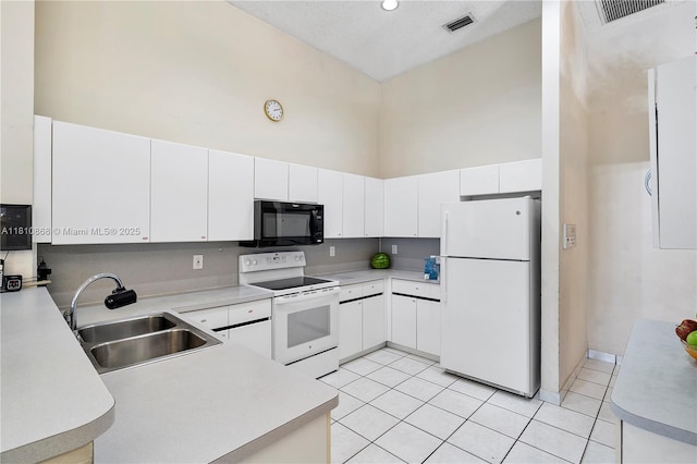 1357 Camellia Ln, Weston, FL 33326 - kitchen with white appliances, a sink, high vaulted ceiling, light countertops, and light tile patterned floors