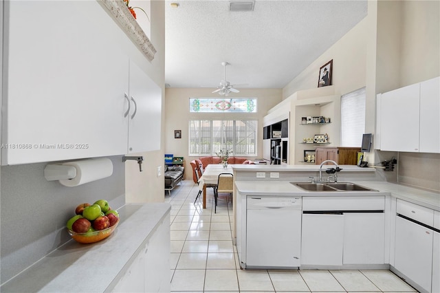 1357 Camellia Ln, Weston, FL 33326 - kitchen with white dishwasher, a sink, a peninsula, light countertops, and a textured ceiling