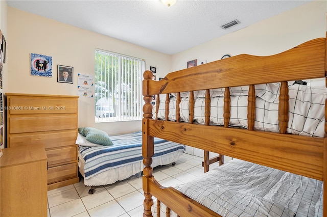 1357 Camellia Ln, Weston, FL 33326 - bedroom with light tile patterned floors and a textured ceiling