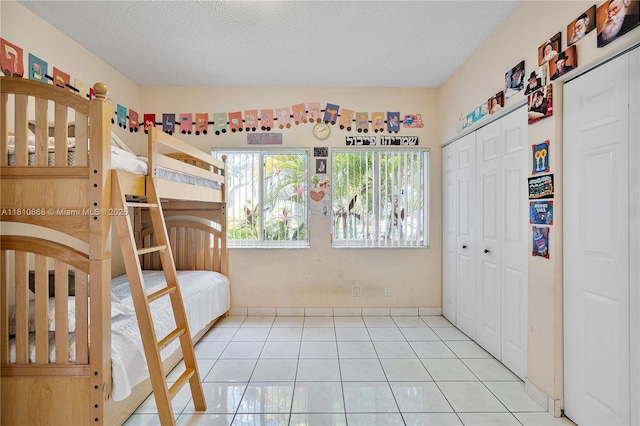 1357 Camellia Ln, Weston, FL 33326 - bedroom featuring light tile patterned floors, a closet, and a textured ceiling