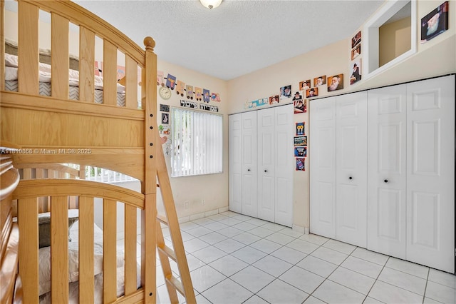 1357 Camellia Ln, Weston, FL 33326 - unfurnished bedroom with two closets, light tile patterned flooring, and a textured ceiling