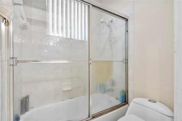 1357 Camellia Ln, Weston, FL 33326 - bathroom featuring toilet and combined bath / shower with glass door