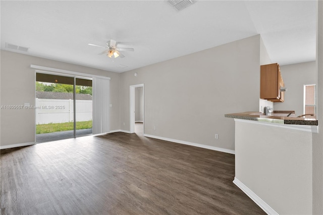 7974 Niagara Falls Ct, Orlando, FL 32825 - unfurnished living room featuring ceiling fan, baseboards, and dark wood finished floors