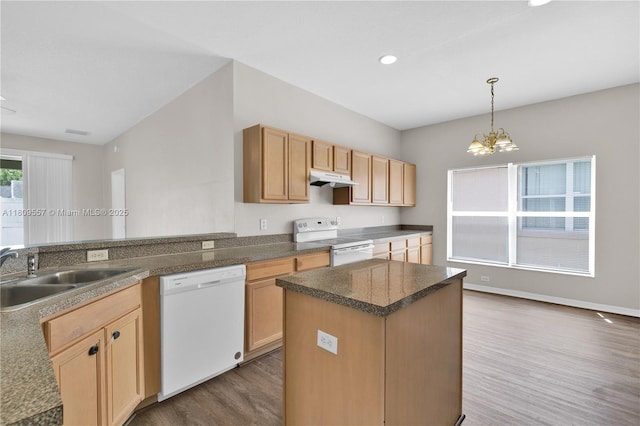 7974 Niagara Falls Ct, Orlando, FL 32825 - kitchen with white appliances, a sink, dark wood-style floors, under cabinet range hood, and a chandelier
