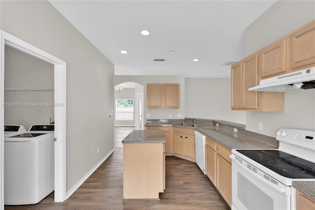 7974 Niagara Falls Ct, Orlando, FL 32825 - kitchen featuring white appliances, light brown cabinets, arched walkways, washer and dryer, and under cabinet range hood