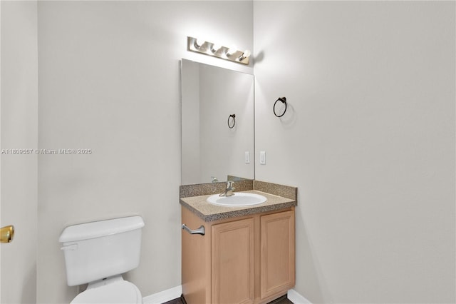 7974 Niagara Falls Ct, Orlando, FL 32825 - bathroom with toilet, vanity, and baseboards