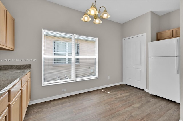 7974 Niagara Falls Ct, Orlando, FL 32825 - unfurnished dining area with light wood-style floors, a chandelier, and baseboards