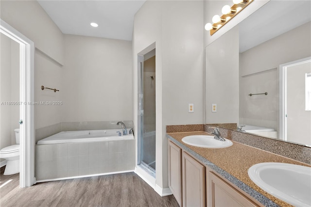 7974 Niagara Falls Ct, Orlando, FL 32825 - bathroom with toilet, a bath, wood finished floors, double vanity, and an enclosed shower