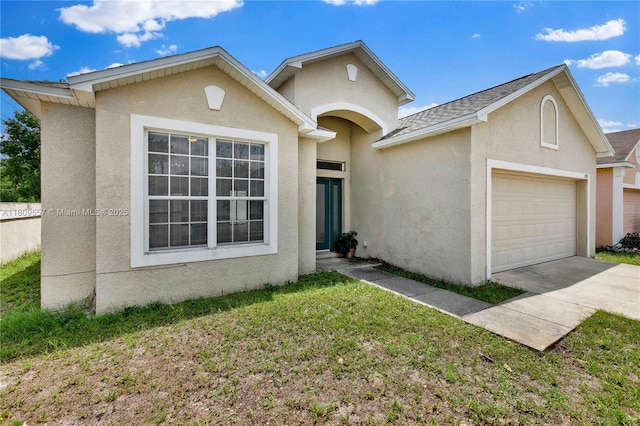 7974 Niagara Falls Ct, Orlando, FL 32825 - view of front of property featuring a garage, stucco siding, driveway, and a front lawn