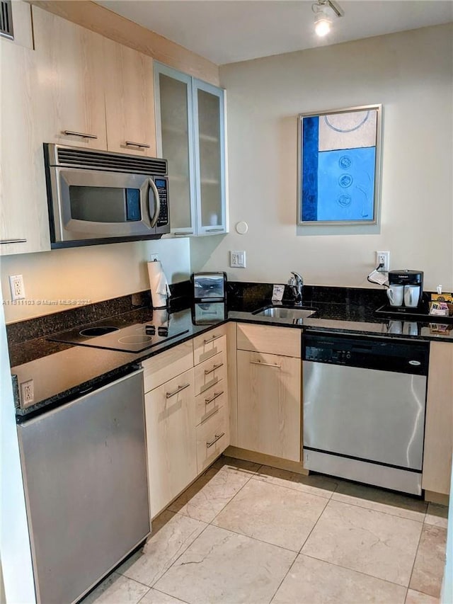 2670 E Sunrise Blvd Unit 523, Fort Lauderdale, FL 33304 - kitchen featuring appliances with stainless steel finishes, a sink, light brown cabinetry, and glass insert cabinets