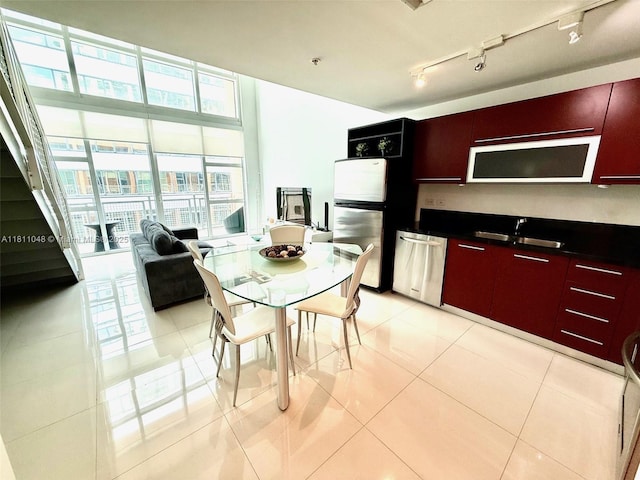 253 NE 2nd St Unit 625, Miami, FL 33132 - dining space featuring rail lighting and light tile patterned floors