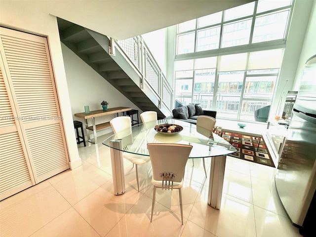 253 NE 2nd St Unit 625, Miami, FL 33132 - tiled dining space featuring stairway