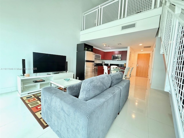 253 NE 2nd St Unit 625, Miami, FL 33132 - living area featuring a high ceiling, baseboards, and light tile patterned floors