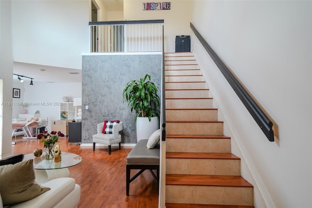 14816 SW 104th St Unit 85, Miami, FL 33196 - staircase featuring wood finished floors, a towering ceiling, and baseboards