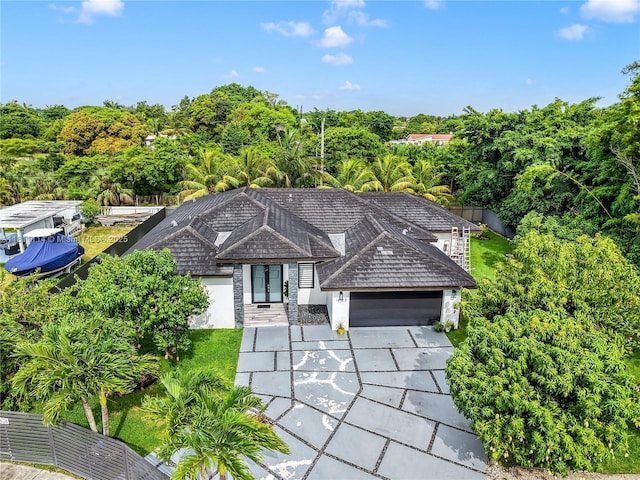 19120 SW 127th Pl, Miami, FL 33177 - view of front of house featuring an attached garage, stucco siding, concrete driveway, and view of scattered trees
