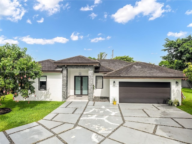 19120 SW 127th Pl, Miami, FL 33177 - view of front of home featuring stucco siding, a garage, french doors, driveway, and a front yard