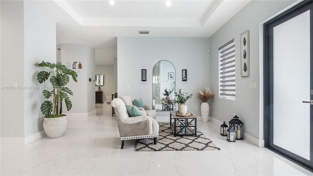 19120 SW 127th Pl, Miami, FL 33177 - living area featuring marble tiled flooring, a tray ceiling, arched walkways, recessed lighting, and baseboards