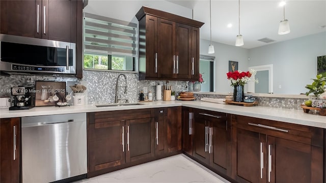 19120 SW 127th Pl, Miami, FL 33177 - kitchen with stainless steel appliances, a sink, light marble finish floors, tasteful backsplash, and light countertops