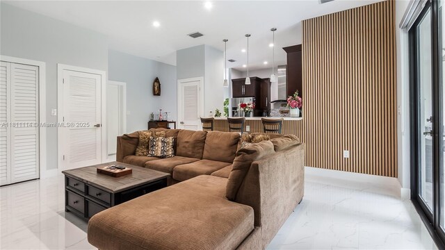 19120 SW 127th Pl, Miami, FL 33177 - living area featuring light marble finish floors, recessed lighting, and healthy amount of natural light