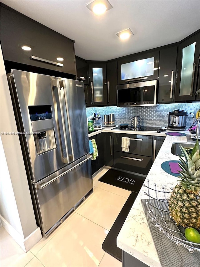 9350 Fontainebleau Blvd Unit 414, Miami, FL 33172 - kitchen featuring stainless steel appliances, dark cabinets, light tile patterned floors, and tasteful backsplash
