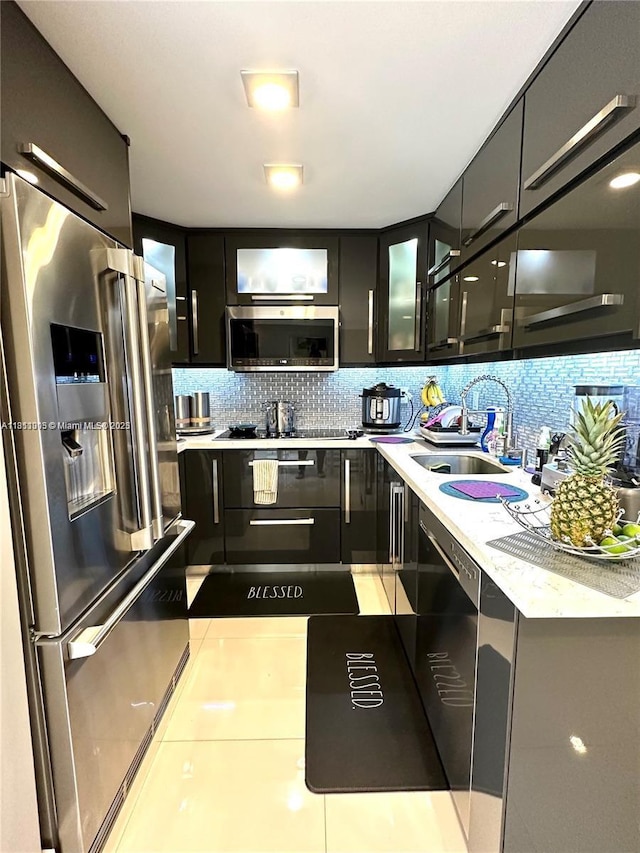 9350 Fontainebleau Blvd Unit 414, Miami, FL 33172 - kitchen with appliances with stainless steel finishes, a sink, backsplash, light countertops, and glass insert cabinets