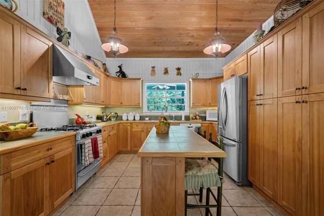 15820 SW 250th St, Homestead, FL 33031 - kitchen featuring stainless steel appliances, wooden ceiling, tile countertops, extractor fan, and a kitchen island