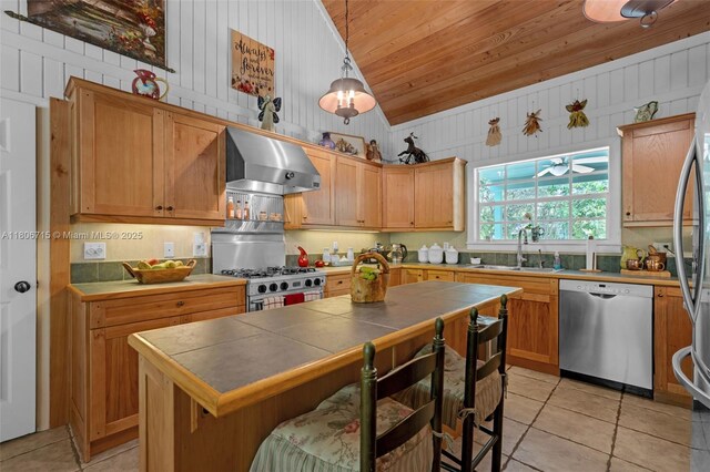 15820 SW 250th St, Homestead, FL 33031 - kitchen featuring stainless steel appliances, wall chimney exhaust hood, vaulted ceiling, tile countertops, and wood ceiling
