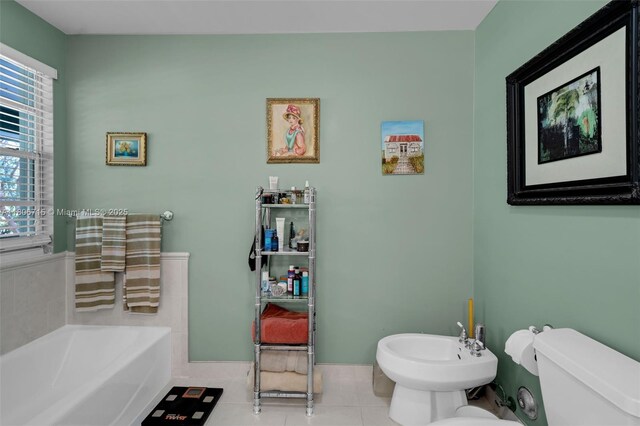 15820 SW 250th St, Homestead, FL 33031 - full bath with a bidet, toilet, a bath, tile patterned floors, and baseboards