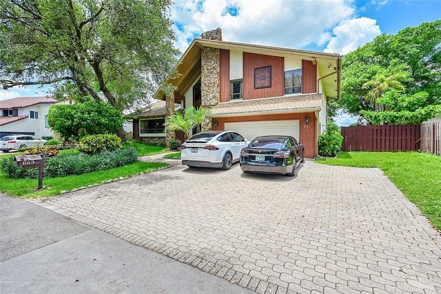863 W Coco Plum Cir, Plantation, FL 33324 - view of front facade with decorative driveway, an attached garage, stone siding, and a chimney